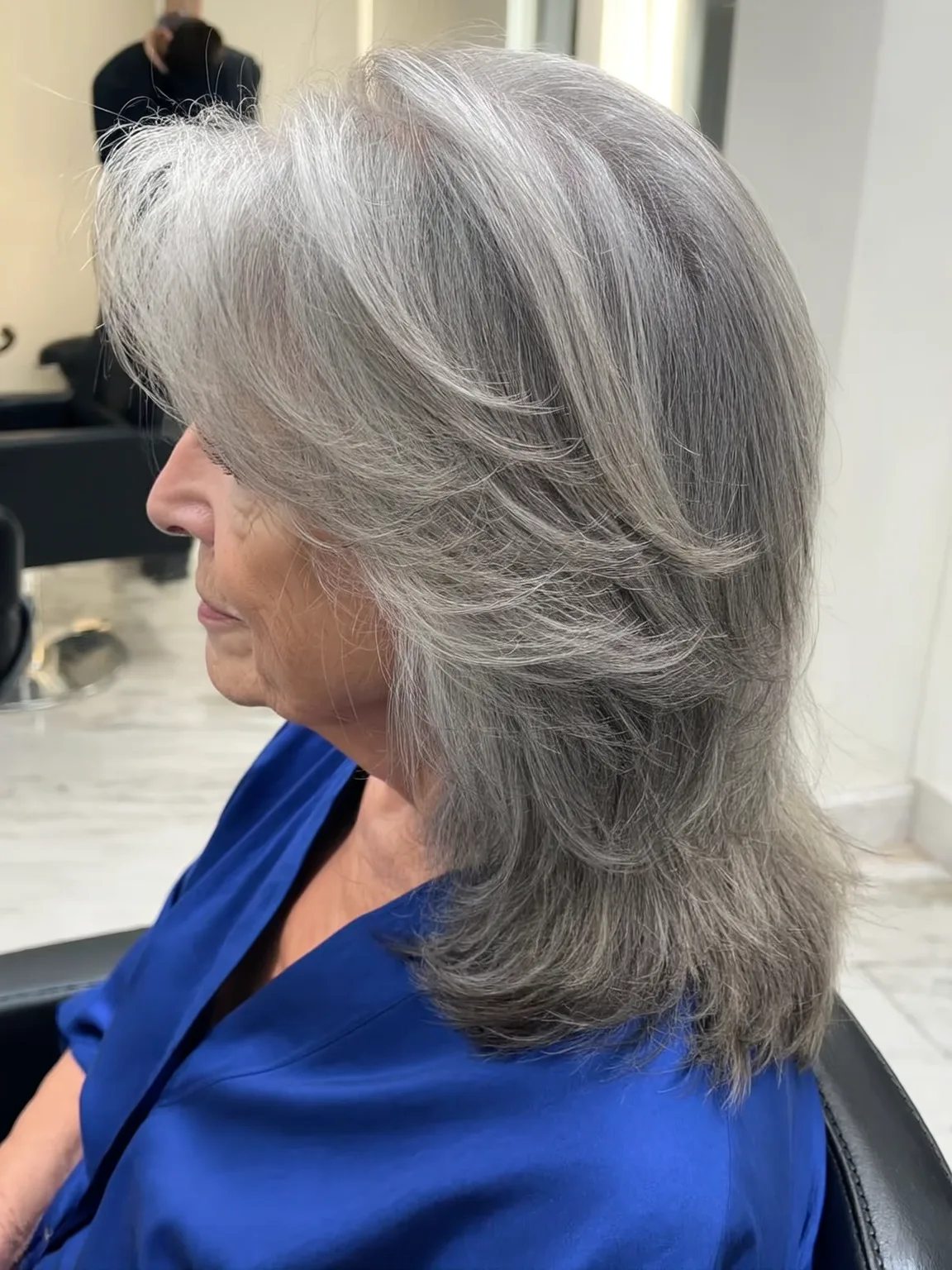 Voluminous Feathered Silver Frost Layers with Side-Swept Bangs